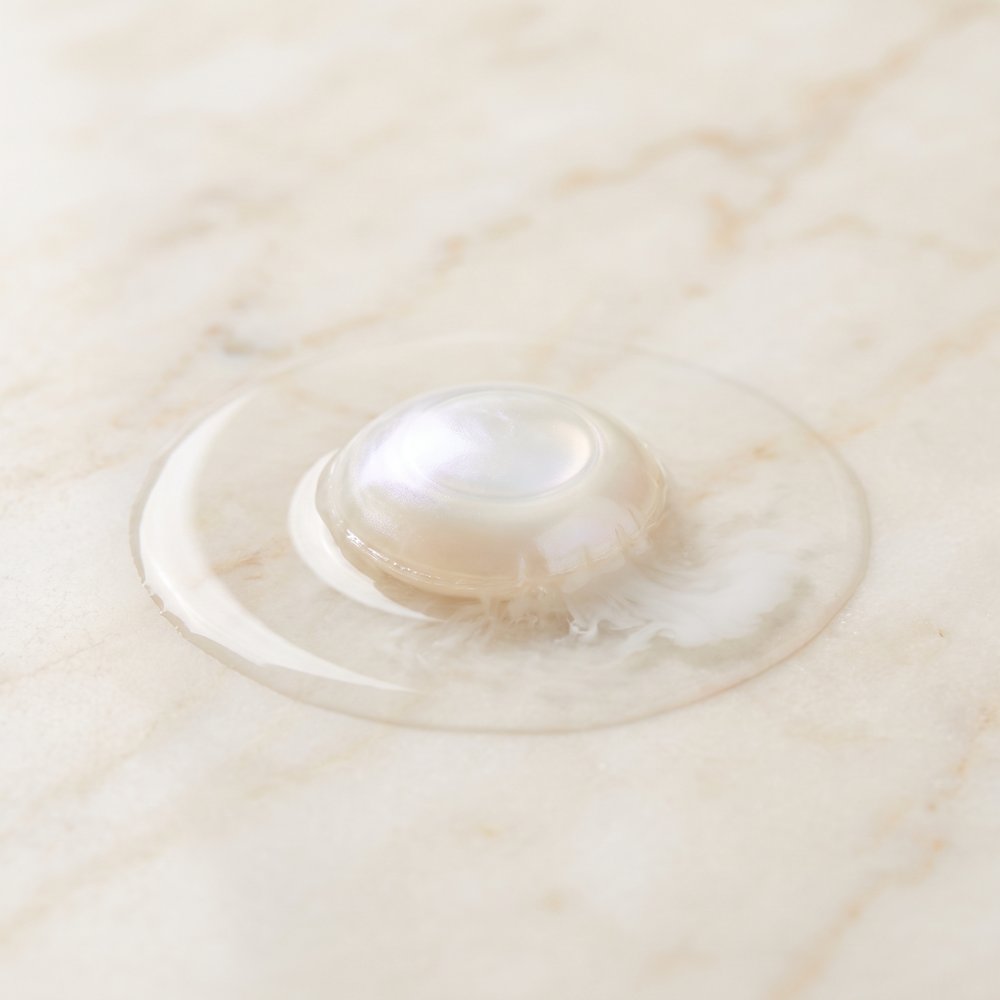 A pearl dissolving in water